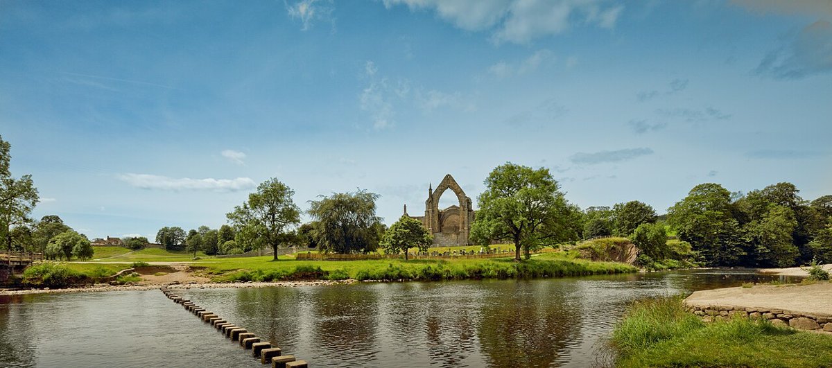 Bolton Abbey priory ruins across the River Wharfe and stepping stones